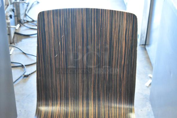 5 wood pattern dining chair with metal legs, slight scratches, sleek design, ideal for modern interiors.