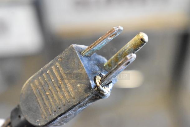 Close-up view of a worn electrical plug, likely from a 2018 Crathco 3311 Frozen Beverage Machine. Some corrosion visible.