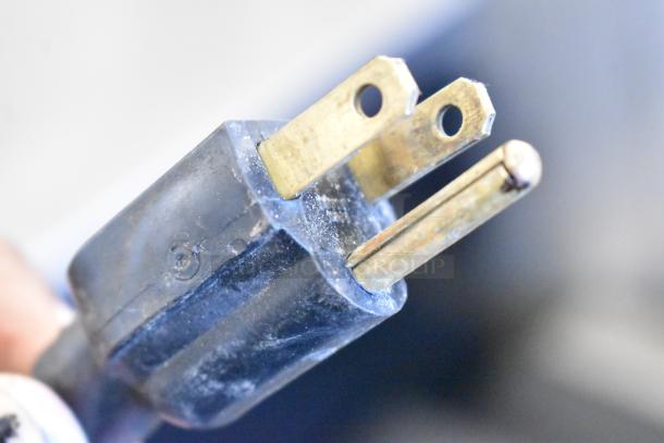 Close-up of a power plug for the Crathco 3311 Frozen Beverage Machine. Three-prong, showing slight wear.