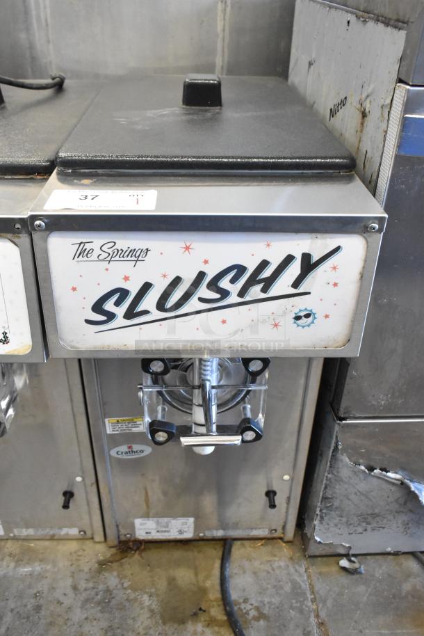 2018 Crathco 3311 stainless steel frozen beverage machine, single flavor, 115V, commercial grade, labeled "The Springs Slushy."