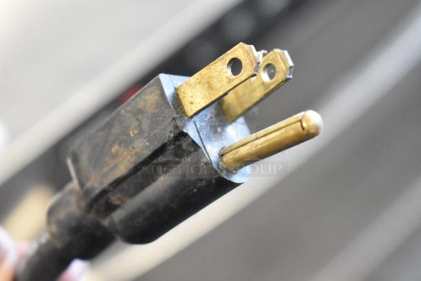 Close-up of a worn electrical plug for a 2018 Crathco 3311 frozen beverage machine, showing visible wear on prongs.