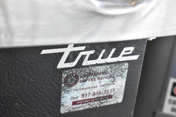 2017 True TBB-4 commercial 3-door back bar cooler, metal, 115 volts, with visible service label for repairs.