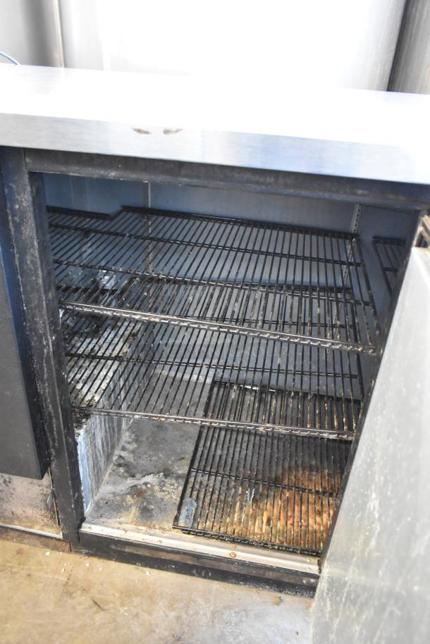 2017 True TBB-4 commercial back bar cooler, three-door, metal construction, 115 volts, 1 phase, interior shelves visible.