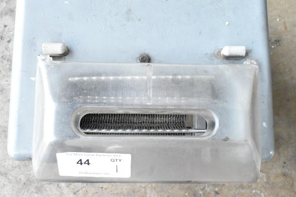 Metal commercial countertop electric meat tenderizer, 115 volts, 1 phase, visible label marked with auction info, slightly used condition.