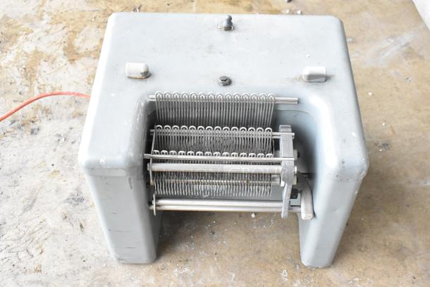 Metal commercial countertop electric meat tenderizer, 115 volts, 1 phase. Used condition with visible wear.