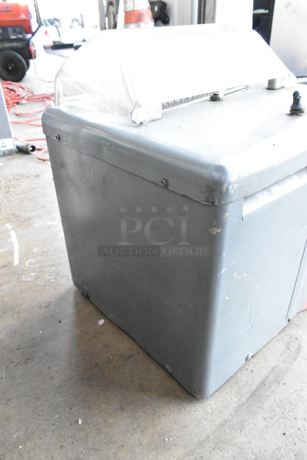 Metal commercial countertop electric meat tenderizer, 115 volts, 1 phase. Shows signs of wear with visible scratches on the surface.