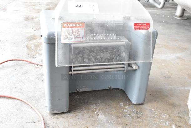 Metal commercial countertop electric meat tenderizer, 115V, 1 phase. Visible warning labels, sturdy build, used condition.