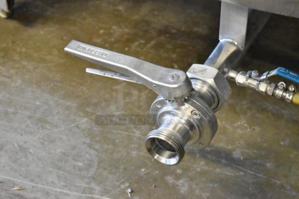 Stainless steel valve of an 8.75 BBL / 367-gallon beer tax determination tank, featuring secure fittings and "Tassalini" marking.