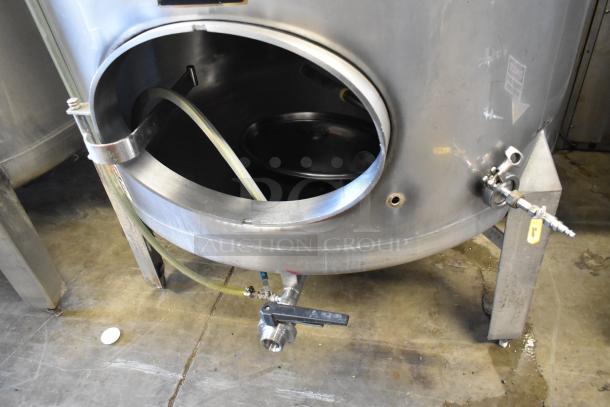 Stainless steel 8.75 BBL beer tank for tax determination, with visible ports and valve. Industrial condition.