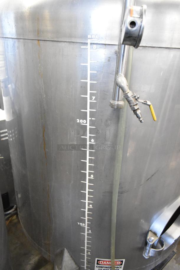 Stainless steel commercial 8.75 BBL beer tank with measurement markings, spigot, and “Danger” confined space label, in good condition.