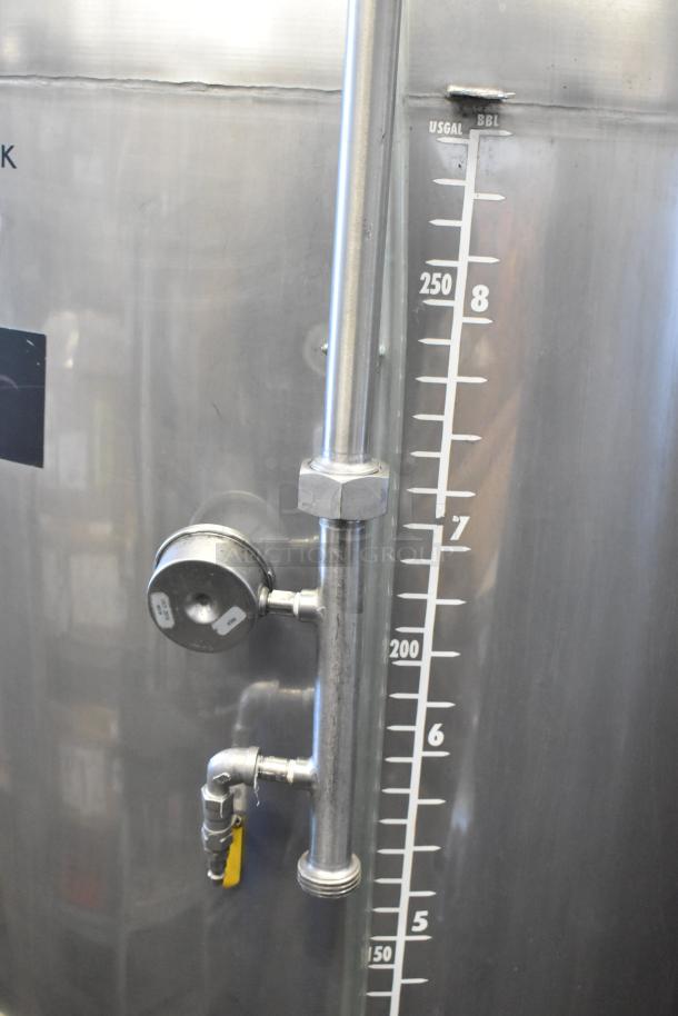 Stainless steel 8.75 BBL beer tax determination tank with clear volume markings and attached pressure gauge, in good condition.