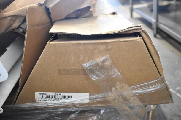 Cardboard box containing various brand new scratch and dent light fixtures. Box has a label with product codes.