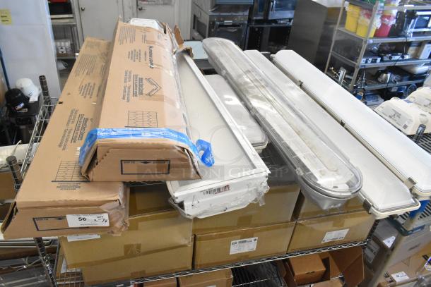Seven light fixtures, including Lithonia Lighting GTL 4 40L GZ10 LP840, in new condition with packaging visible.