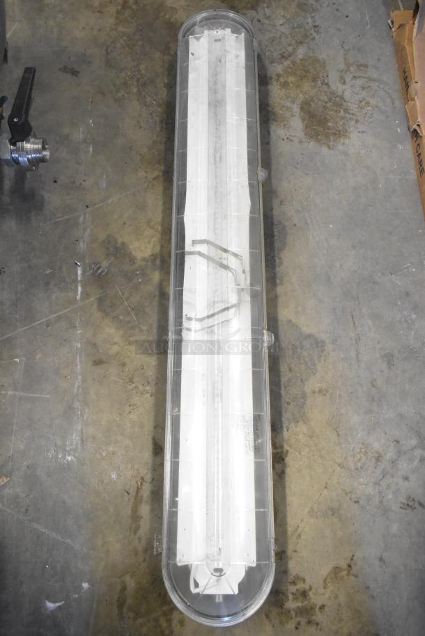 Set of 7 light fixtures, including Lithonia Lighting GTL 4 40L GZ10 LP840, in good condition, featuring clear casing.