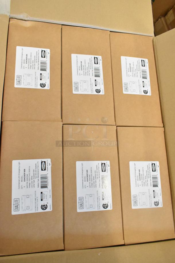 6 boxes of Dual Lite EVHC6IDP-WM commercial LED lights, new. Labels show model and specs for emergency lighting.