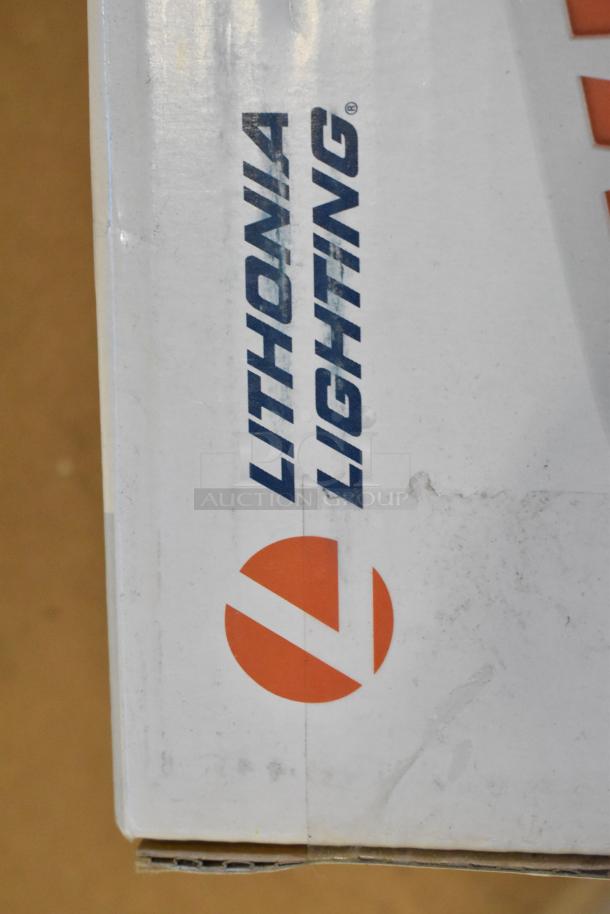 Box with Lithonia Lighting logo, containing brand new scratch and dent emergency lighting items including exit signs.