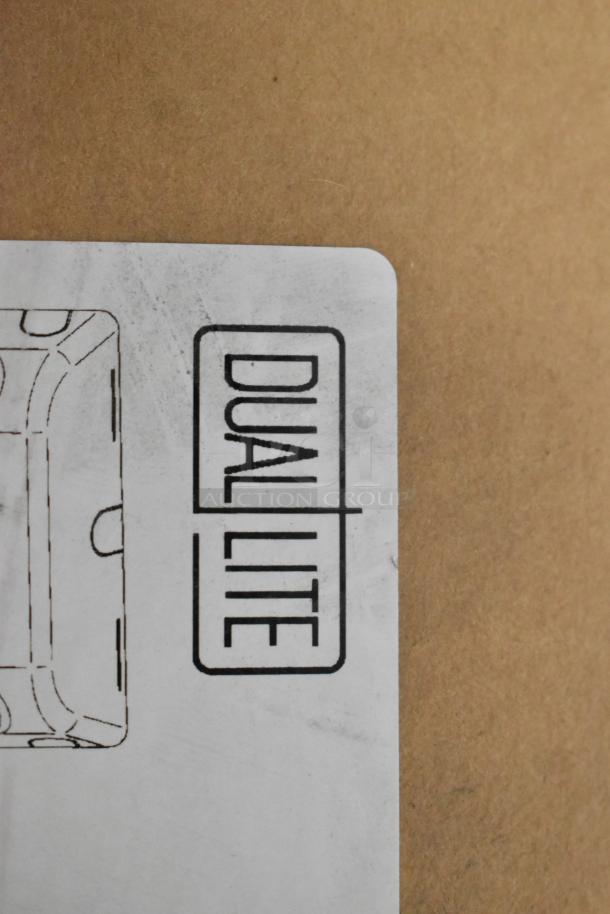 Box with "Dual Lite" label, part of 16 new scratch and dent items. Includes exit signs and LED emergency lights.