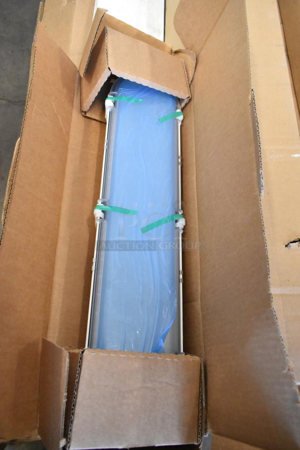 16 new scratch-and-dent boxes, including exit signs and Dual Lite LED emergency light. Green-tied blue packaging inside cardboard.