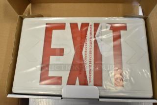 Box of 6 brand new exit signs, visible scratch and dent. White plastic with red lettering.