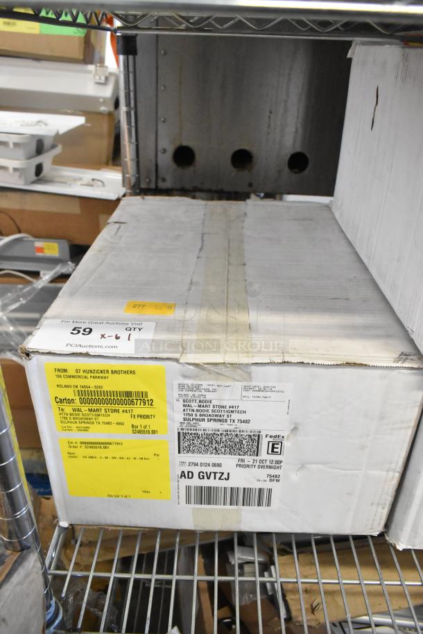 Box of 6 brand new exit signs, scratch and dent condition. Visible shipping labels and barcodes on packaging.