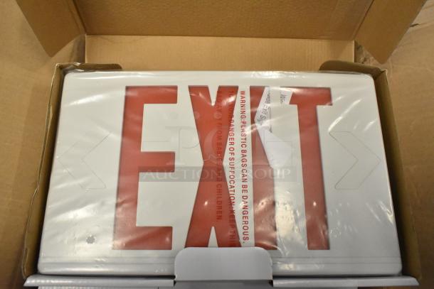Box of 6 brand new exit signs, slight scratch and dent visible. Safety warning on packaging.