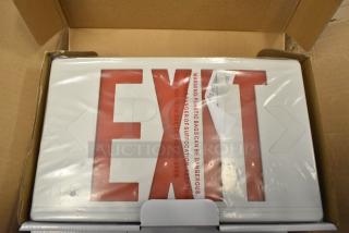 Box of 6 brand new exit signs, slight scratch and dent visible. Safety warning on packaging.