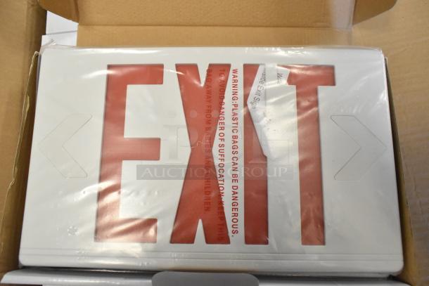 Box of 6 brand new scratch and dent exit signs, red lettering, in packaging. Tags warn of plastic suffocation risk.