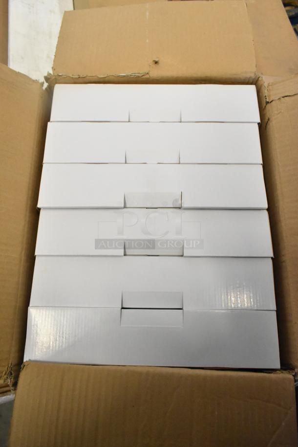 Box of 6 brand new scratch and dent exit signs, packaged in white boxes, visible inside an open cardboard box.