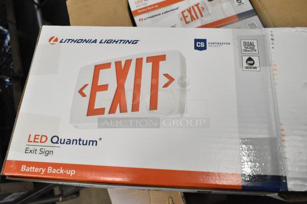 Box of six Lithonia Lighting LED Quantum exit signs, new with minor scratches, featuring dual voltage and battery backup.