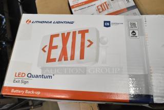 Box of six Lithonia Lighting LED Quantum exit signs, new with minor scratches, featuring dual voltage and battery backup.