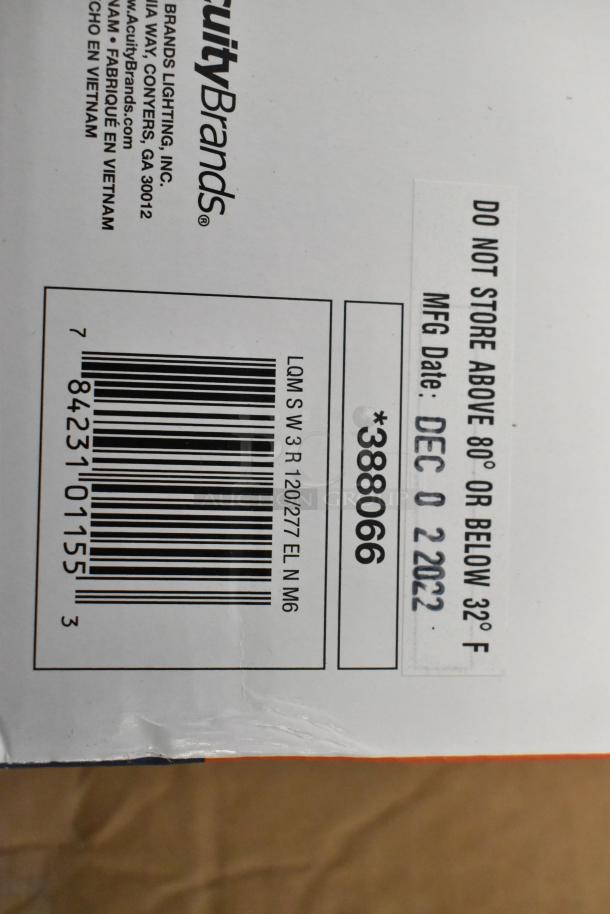 Box of 6 brand new Acuity Brands exit signs, scratch and dent condition. Labeled "LQM S W 3 R 120/277 EL N M6." MFG date: Dec 02, 2022.