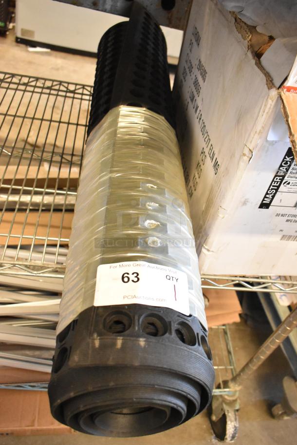 Black Anti-Fatigue Floor Mat, rolled, perforated design, wrapped in plastic with auction tag, new condition.