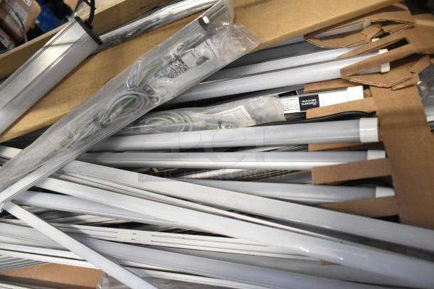 Boxes of various fluorescent lights, including Banner WBL32C285PB, brand new with minor scratches in packaging.