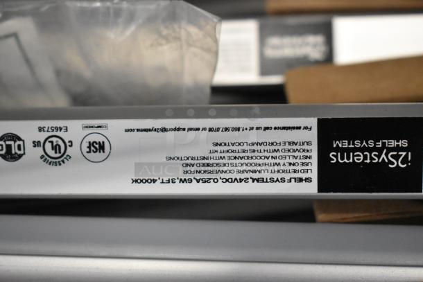 Two boxes of various fluorescent lights, brand new with minor scratches, including Banner WBL32C285PB, double your bid value.