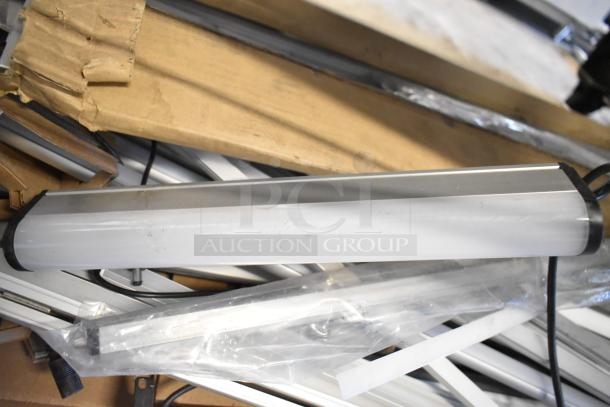 Two brand new scratch and dent boxes of various fluorescent lights, including Banner WBL32C285PB model, seen amidst packaging.