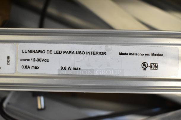 Two boxes of various fluorescent lights, including Banner WBL32C285PB, brand new scratch and dent, made in Mexico.