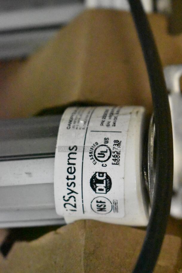 Two brand new scratch and dent boxes of various fluorescent lights, including Banner WBL32C285PB model, with visible safety certifications.