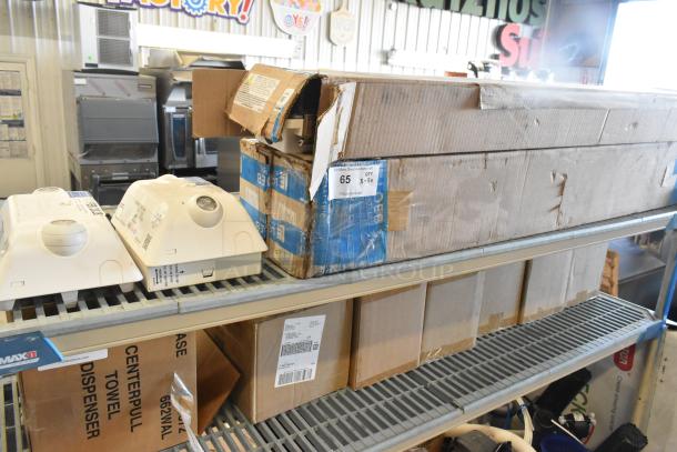 5 new scratch and dent boxes including Dual Lite Emergency Light; visible damage on packaging.