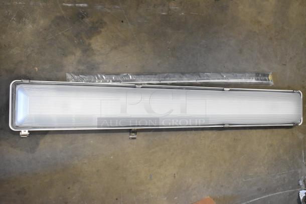 Brand new Dual Lite emergency light in original packaging, 4 feet long, white, with minor scratches, includes protective cover.