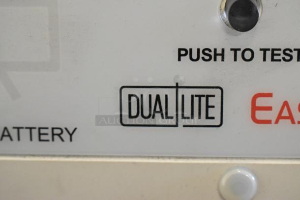 Dual Lite emergency light control panel with "Push to Test" and battery indicator. Brand marking visible.