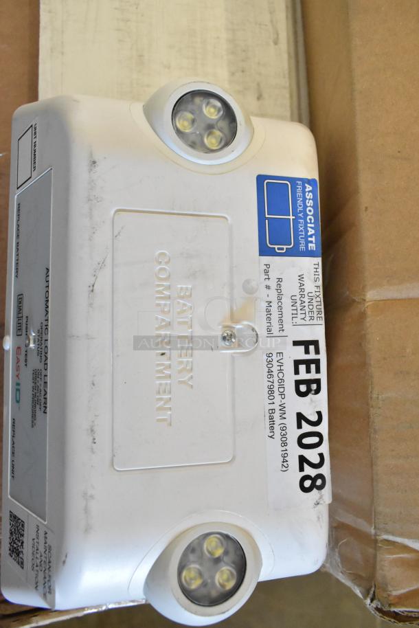 Brand new Dual Lite emergency light, scratch and dent, with battery compartment and warranty tag, expires Feb 2028.