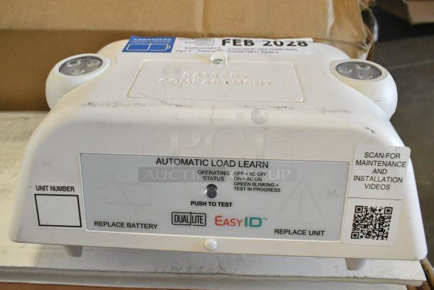 Dual Lite emergency light, new with minor scratches. Automatic load learn feature, push to test; replace battery indicator; QR code for videos.