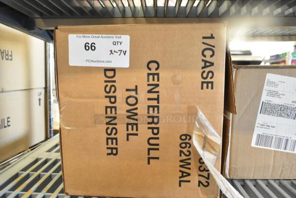Box labeled "Center Pull Towel Dispenser" marked 1/Case, new condition, auction sticker with lot number 66 visible.