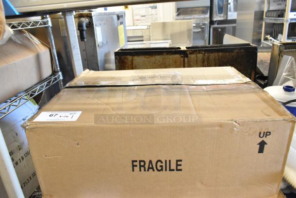 Cardboard box labeled "FRAGILE" containing 7 brand new scratch and dent items, including Dual Lite products. Box is sealed and marked for careful handling.