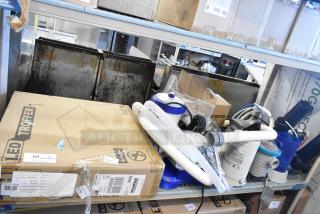 Various items including an LED troffer in a cardboard box and several filter pumps with hoses, all in fair condition.