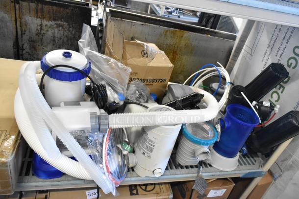 Various items including LED troffer and filter pumps, hoses, and fittings on display shelf. Mixed condition, 8 items total.
