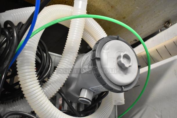 8 various items, including an LED troffer and filter pumps. Highlighted is a filter pump with visible hoses, in good condition.