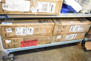 4 new scratch and dent 2x2 LED troffers in original boxes. Grainger labels visible, model details not specified.