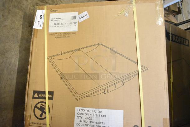 4 new scratch and dent Elumigen 2x2 LED troffers in original packaging, model TL2XR0USA4CAD0W35-B, energy-efficient lighting.