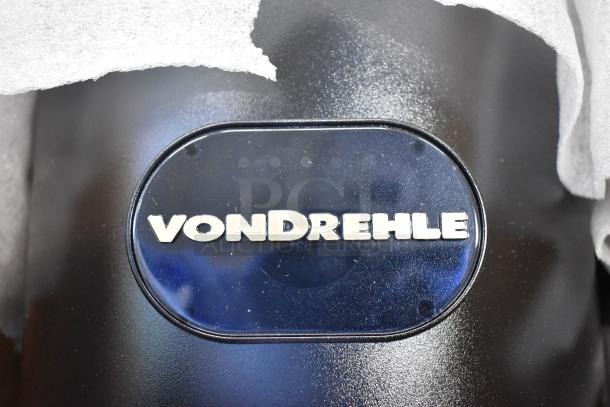 VonDrehle center pull towel dispenser, brand new, scratch and dent condition, black with logo.